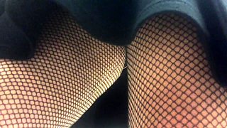 Striking amateur lady in fishnet stockings upskirt in public