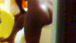 Hidden surveillance in the bathroom of an ebony woman with a nice body
