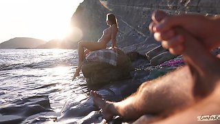 Breathtaking girl with a perfect body masturbates her pussy on a beach while stranger is jerking off on her