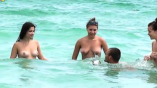 Cute looking young nudists walks on the beach