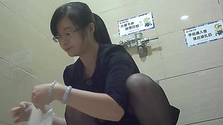 Chinese office milf lady pissing in the toilet
