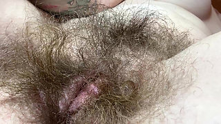 Hairy girl rubbing out her big clit