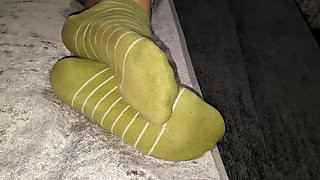 She slowly takes off her socks while I film her