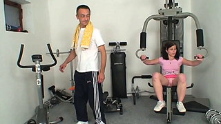 A young slut gets fucked by an older man in the gym