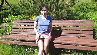 Sunny, but windy day in may 2020. A bench in a garden