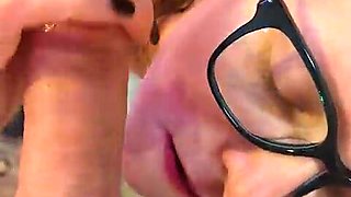 Nerdy cougar deep throats pink cigar on her knees