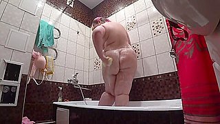 Lesbian has installed a in the bathroom at his girlfriend. Peeping behind a bbw with a big ass in the shower. Voyeur