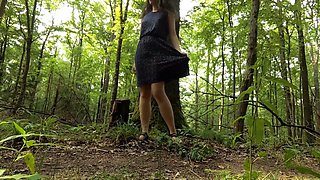Young woman walks around naked in a forest and masturbates by a trail